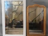 two mirrors that are sitting on a shelf next to each other