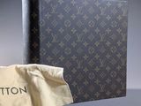 louis vuitton book with a bag on the cover and a cloth bag on the floor