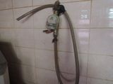 a water hose attached to a wall in a bathroom