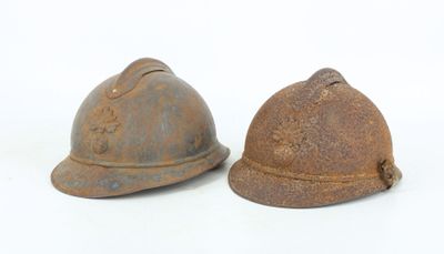 pair of old rusty helmets on a white background