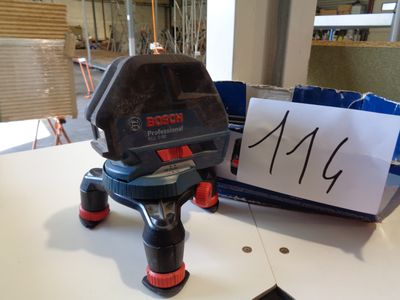 a black and red object on a table next to a sign