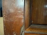 a close up of a wooden door with peeling paint on it