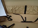 an open suitcase with a strap on the inside of it