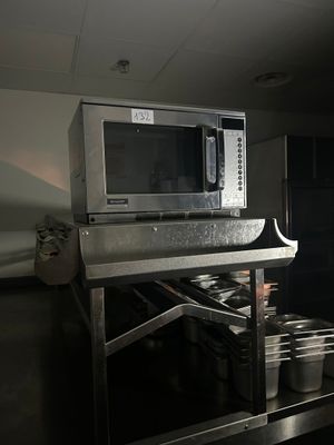 a microwave that is sitting on a table in a kitchen