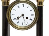 a black and gold clock with a white face