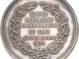an image of a silver medal with a wreath on it