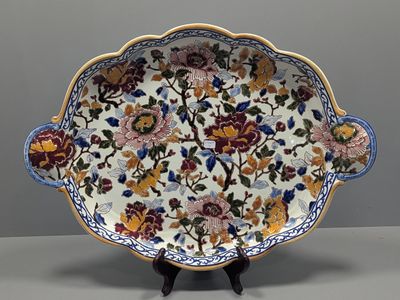 a close up of a plate with flowers on it on a stand