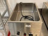 an image of a stainless steel sink sitting on top of a metal table