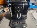 a black coffee machine sitting on top of a table