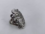a close up of a silver ring on a white surface