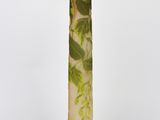 an image of a tall vase with a green and white design on it