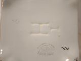 a white plate with a design on it on a table