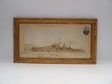 an old picture of a ship in a frame on a wall