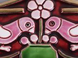 a close up of a decorative wall hanging with birds and flowers