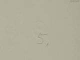 a drawing of the number 5 is shown on a piece of paper