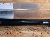 a black flashlight sitting on top of a wooden table
