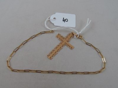 a gold chain with a cross and a tag on it