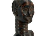 wooden statue of a woman with a headband and a long neck