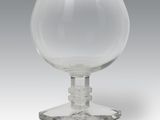 crystal goblet on a clear base on a grey background