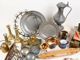 a lot of silver and brass items on the table