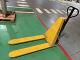 a fork lifter sitting on the floor in a warehouse