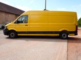 a yellow van that is parked in a parking lot
