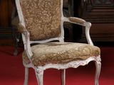 a chair that is on a red carpet in a room