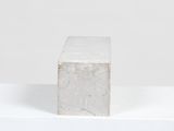 concrete block sitting on top of a white shelf in a room