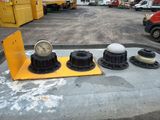 three clocks sitting on top of a table in a parking lot