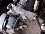 a close up of a motorcycle engine with a clock on it ' s side