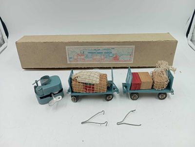 a blue toy truck with luggage on the back of it
