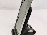 a cell phone that is on a stand on the table