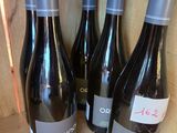 three bottles of wine are sitting on a shelf in a cabinet