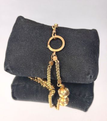 a black bag that has a gold chain on it