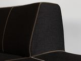 a close up of the back of a black couch with gold piping