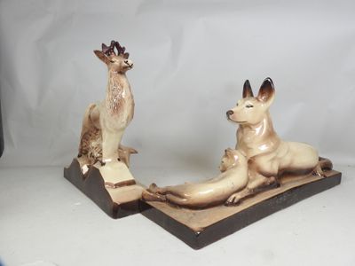 two figurines of animals that are sitting on a table