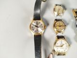 a lot of watches that are sitting on a table