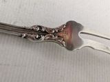 a fork and a spoon on a white surface