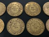 six different types of gold coins on a black surface