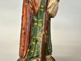 a figurine of a man with a hat and robe