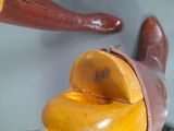 a wooden shoe that is sitting on top of a table