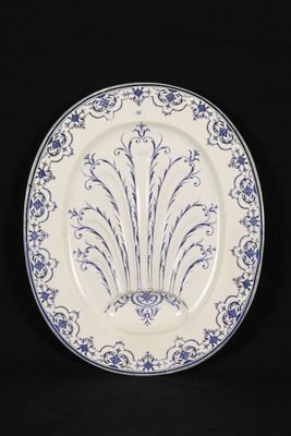 a blue and white plate with a design on it