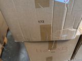 a cardboard box with a sticker on it sitting on a pallet
