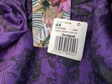 the back of a purple dress with a picture of a woman with a flower on it