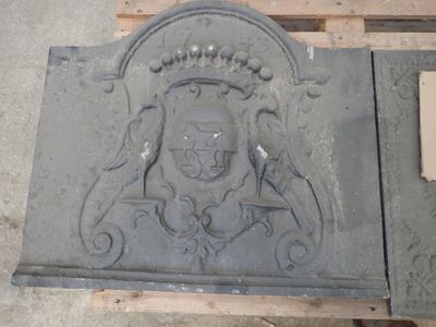 a stone plaque with a coat of arms and a crown on it