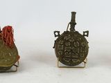 three small metal objects sitting on top of a white surface