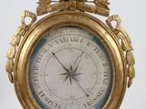 une horloge en or surmontée d'un oiseau