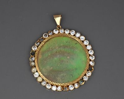 a green jade and diamond pendant