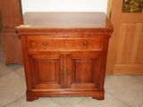 a small wooden cabinet with a drawer on top of it