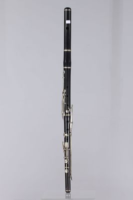 a close up of a black and white clarinet on a clear stand